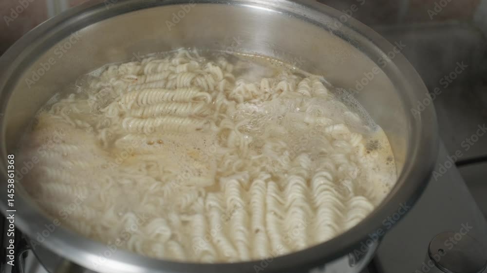noodles cooking in a pot of boiling water in close-up
