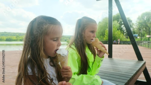 Two sisters girls eating ice cream