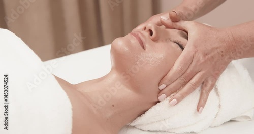 Wallpaper Mural Young woman during a facial massage in a spa. The concept of relaxation, spa and cosmetology. Torontodigital.ca