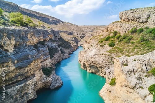 Serene river flowing through majestic canyon landscape under a clear blue sky