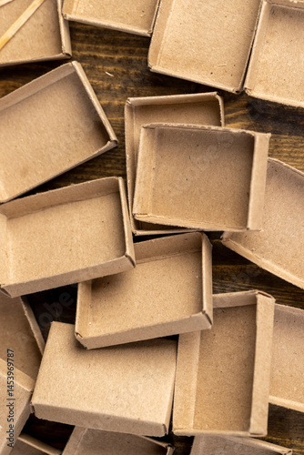 empty cardboard matchboxes are scattered in a chaotic manner