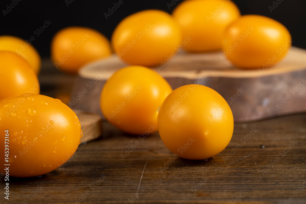 wet tomatoes on the table, tomatoes with drops of water on them, close up, side view