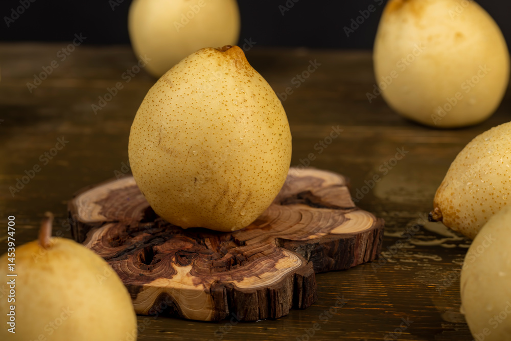 sweet fresh white pear in the kitchen, fruit on an old juniper board