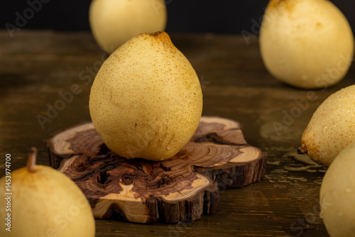 Obraz na płótnie sweet fresh white pear in the kitchen, fruit on an old juniper board w salonie