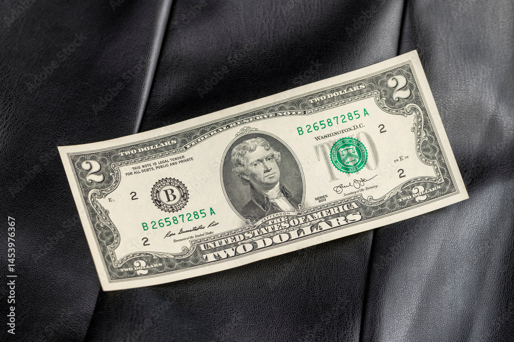 closeup obverse of the banknote with a portrait, banknote on leather fabric
