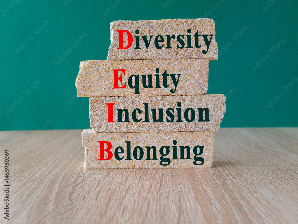 Concept words DEIB diversity equity inclusion belonging on brick blocks. Beautiful green background, wooden table. Business diversity equity inclusion belonging concept