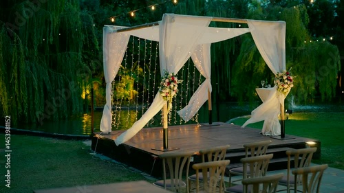 A beautiful chuppah in a green garden in the evening. High quality FullHD footage