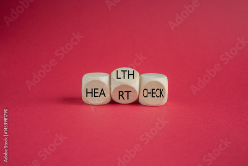 Obraz na płótnie Cubes form the expression 'heart check' and 'health check'. Beautiful red background. Business and medical concept. w salonie