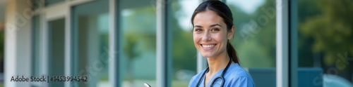 Nurse in scrubs smiles at phone outside hospital, health, outdoor, grounds
