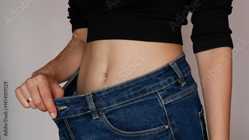 Noticeable weight loss, jeans hanging out at the waist.
