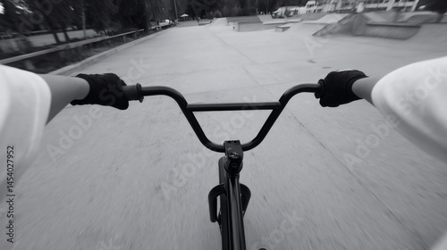 Bmx rider riding towards skatepark in first person view photo