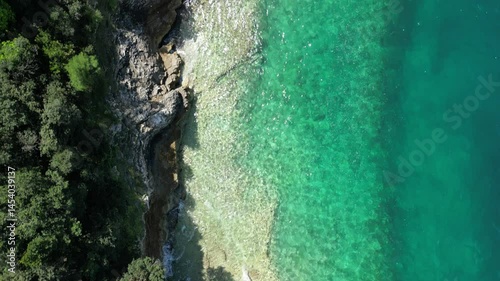Bird's eye drone footage of the shoreline of Pula city in Istrian Peninsula, Croatia on a sunny day
