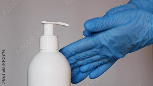 Doctor's hands sanitized with alcohol before patient appointment in medical office.