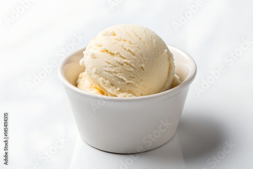 Minimal dessert setup: one scoop of vanilla ice cream in white cup, isolated