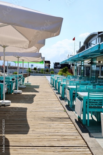 Turquoise outdoor chairs in a fish restaurant at a seaside resort. stylish cafe. High quality photo