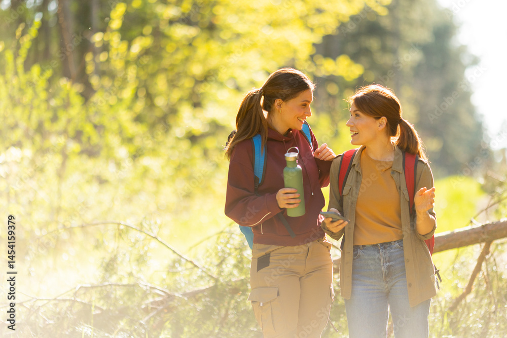 Friends enjoy a joyful hike through lively woodland trails on a bright autumn day filled with laughter and adventure