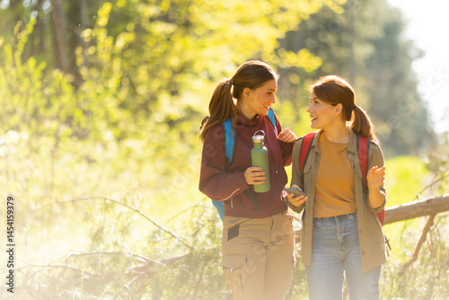 Obraz na płótnie Friends enjoy a joyful hike through lively woodland trails on a bright autumn day filled with laughter and adventure w salonie