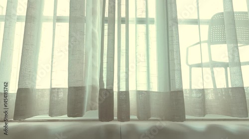 white curtains swayed as the wind blew through on house and morning sunlight.