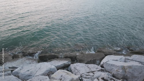 
Slow motion footage of sea waves hitting rocks in evening, coastal sea in Chonburi Province, Thailand.