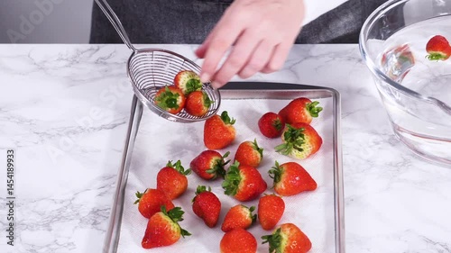 Washed Strawberries Drying on a Paper Towel-Lined Baking Sheet