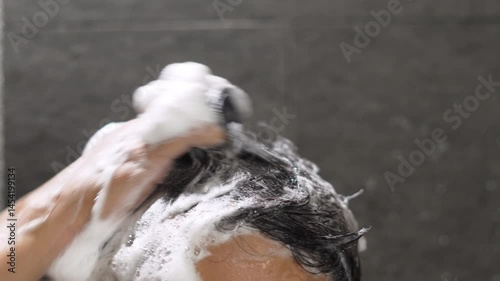 A man washes his hair with anti-dandruff shampoo. photo