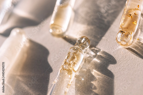 фотографія Close-up of glass pipettes with moisturizing serum with colloidal gold