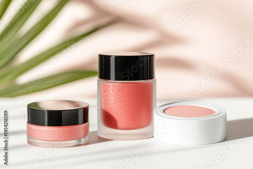 Three stylish makeup containers with modern design against a soft background.