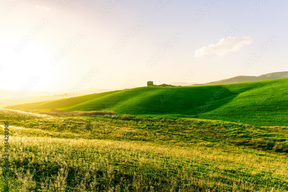 scenery rural view of a contryside farm in green fields and hills with amazing cloudy sky on background scenery rural view of a contryside farm in green fields and hills with amazing cloudy sky on background