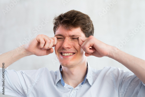 Wallpaper Mural Portrait of young guy with itchy eyes in studio Torontodigital.ca