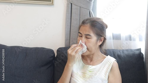 woman sneezing, covering nose, cold symptoms