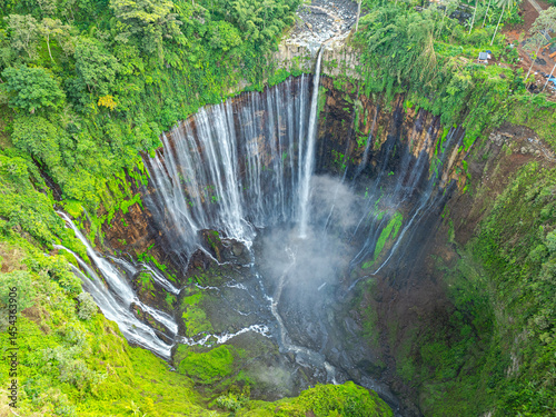 Amazing aerial view Many streams of water flow down in all directions and fall at Tumpak Sewu Waterfall. The waterfalls falling from the semicircular cliffs at Tumpak Sewu are unusually beautiful.
