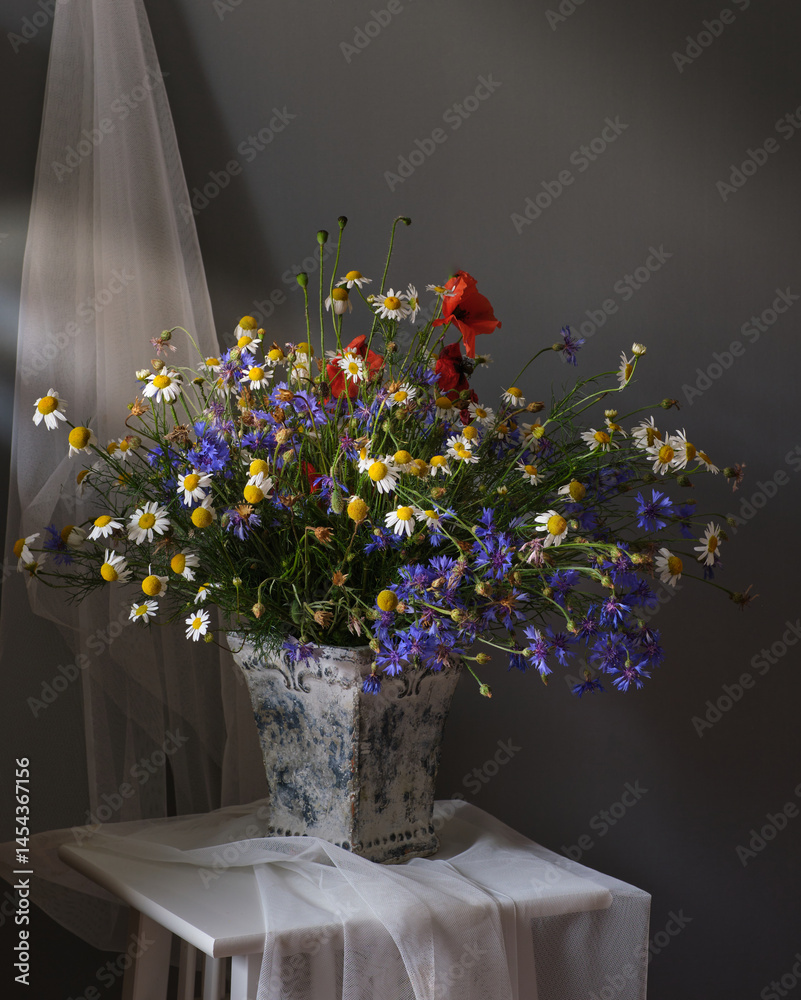 A Beautiful and Vibrant Flower Arrangement Complete with a Tea Set and a Book for Relaxation