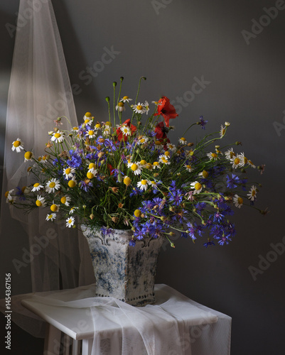 A Beautiful and Vibrant Flower Arrangement Complete with a Tea Set and a Book for Relaxation