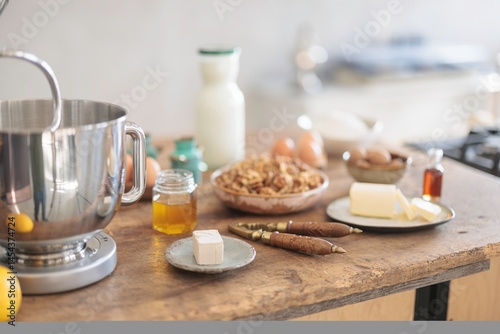 A rustic kitchen comes alive with the art of baking. The stand mixer effortlessly prepares dough for Balkan Cozonac, blending flour, eggs, and sweet flavors for a festive treat