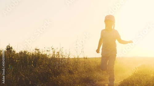 Wallpaper Mural Children dream, happy little girl runs through wheat field, little girl summer meadow runs legs across field, Kid child Baby girl runs with her legs into sunset, Summer day, concept children running Torontodigital.ca