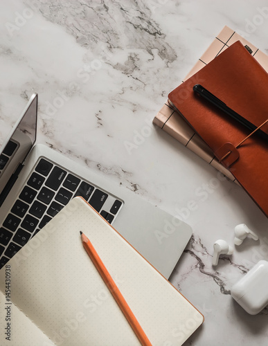 Laptop, notebook on a marble table, top view. Business, education, study concept