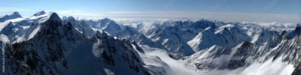 Fototapeta premium Breathtaking Panoramic Scene of Snow-Capped Mountain Summits Glowing in Sunrise Light