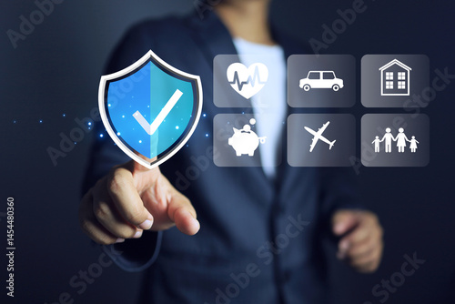 businessman pointing on check mark in protection shield refers to health insurance or health insurance such as work and travel or property and casualty insurance such as car and home.