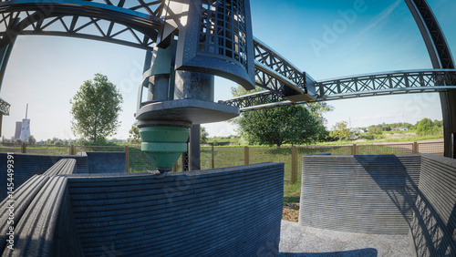 Fototapeta Naklejka Na Ścianę i Meble -  3D printing of a concrete structure in an open field, showcasing advanced construction technology and engineering.