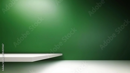Empty white shelf against a deep green wall.