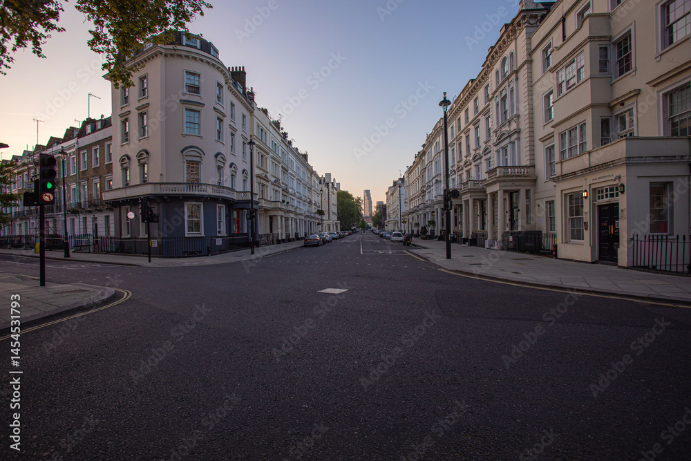 Fototapeta premium A peaceful and quiet urban street at sunrise located in a historic neighborhood setting - Saint Georges Drive - London