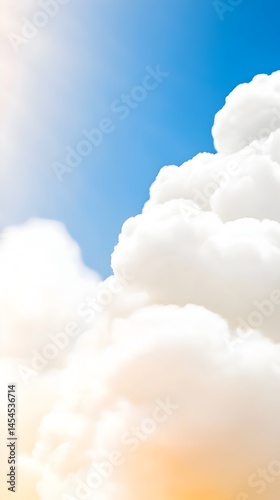Fluffy white cumulus clouds against a vibrant blue sky, sunlit with warm tones at the base