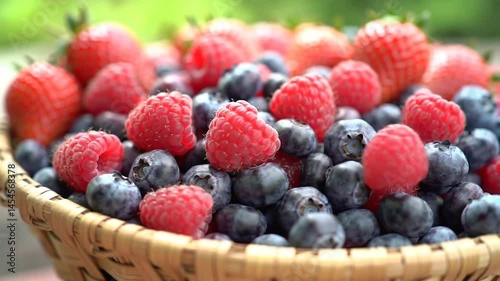 Vibrant Mix of Strawberries, Raspberries and Blueberries in Rustic Woven Basket
