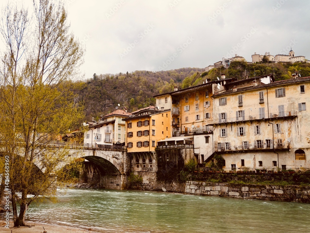 Fototapeta premium View of the Ponte Antonini over a tributary of the river Sesia in Varallo, an Italian Alpine town in valley Valsesia, Varallo (VC), Central Alps, Italy