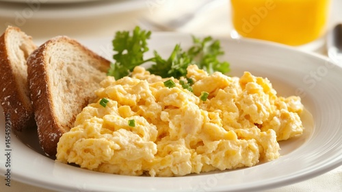 Delicious Scrambled Eggs with Toast, Fresh Parsley and Orange Juice