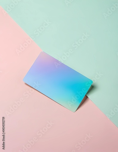 A glossy holographic card lies gracefully on a split pastel surface, showcasing a blend of soft colors. The serene setting captures a calm, contemporary vibe, enhanced by natural light Generative AI
