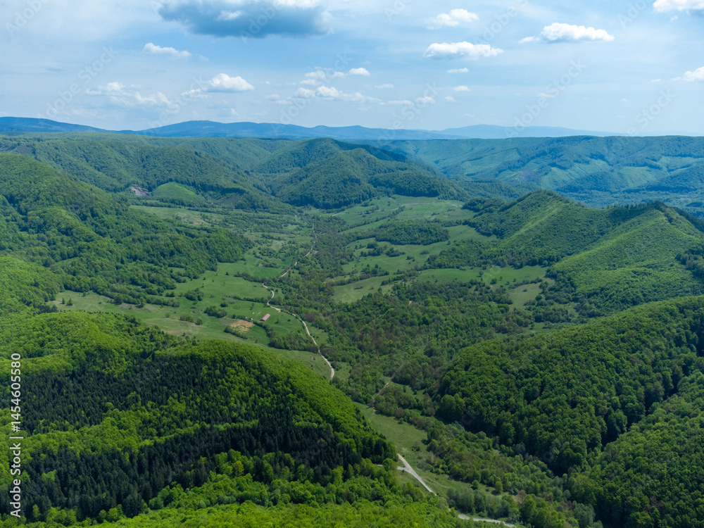 Aerial view with hills and green forests in Transylvania - Romania