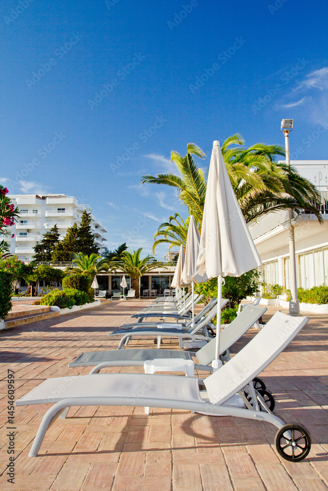 Empty sunbeds near the pool in the European hotel