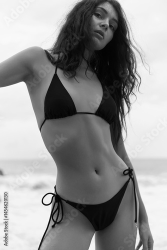 Beautiful young woman on beach. pretty girl in Bikini near sea.