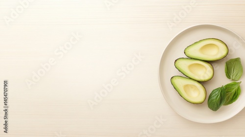 Slicing fresh avocado and basil on a white plate kitchen setting food photography top view perspective